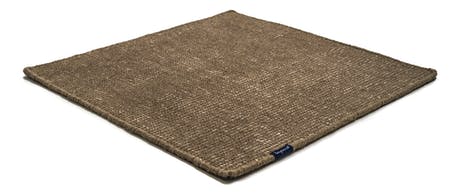Handmade rug made of fine wool and fabrics in a dark brown tone on a white background