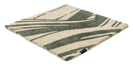 rug made of fabric and handwoven in a zebra design in a green and beige color tone