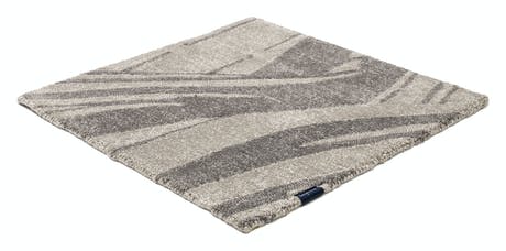 rug made of fabric and handwoven in a zebra design in a ligth gray and dark gray color tone