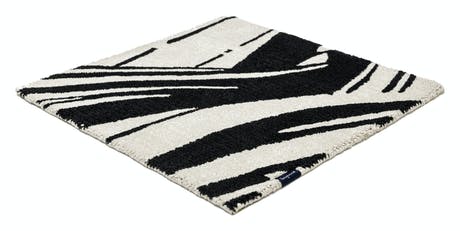 rug made of fabric and handwoven in a zebra design in a black and white color tone