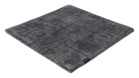 braided and hand-woven rug in wool and velvet in a gray color tone
