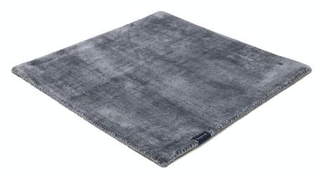 handmade rug in a gray tone with white finishes on a white background
