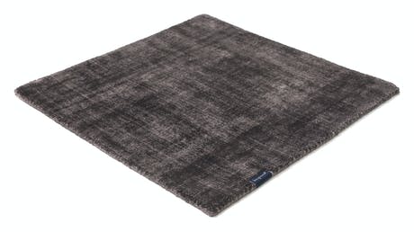 handmade rug in a gray color tone with white finishes on a white background