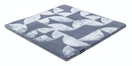 Handmade velvet rug in shades of ligth gray with patch finishes of the same light color