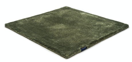 braided and hand-woven rug in wool and velvet in an army green color tone