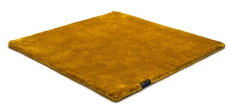 braided and hand-woven rug in wool and velvet in a mustard color tone