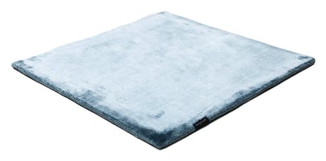 rug made of shiny velvet fabric in a sky blue color tone a white background