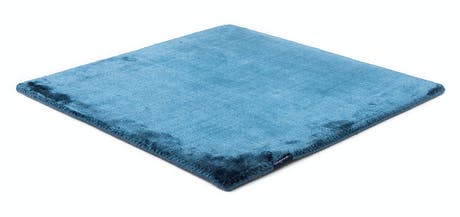 rug made of shiny velvet fabric in a ligth royal blue color tone