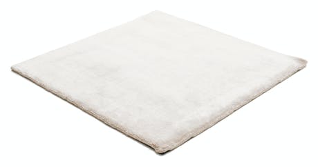 rug made of shiny velvet fabric in a white color tone