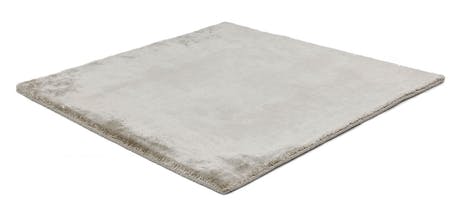 rug made of shiny velvet fabric in a gray color tone on a white background