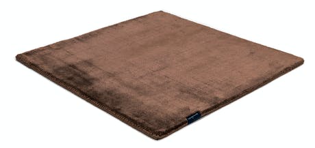 rug made of shiny velvet fabric in a brown color tone