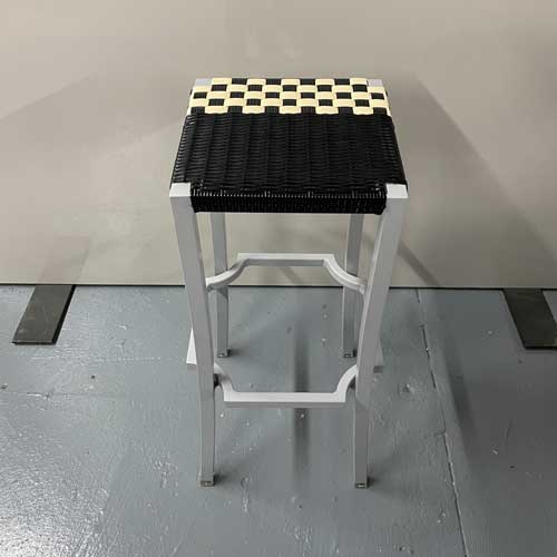 stool made of aluminum base and hand-woven seat in an ivory and black tone