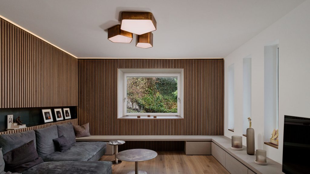 Bat Light LED ceiling lamp with pentagon shapes finished in brass in a living room.