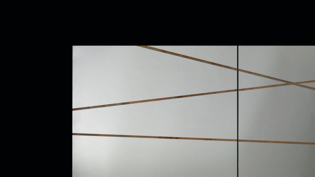 Closeup of Edge Mirror woth silver finish and frame in wood on a black background.