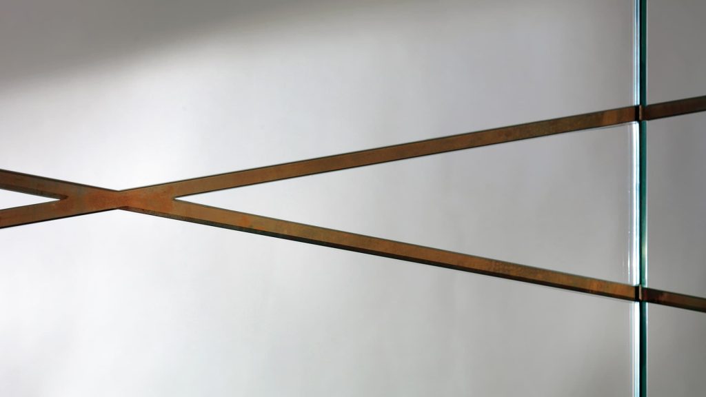 Closeup of Edge Mirror woth silver finish and frame in wood on a black background.