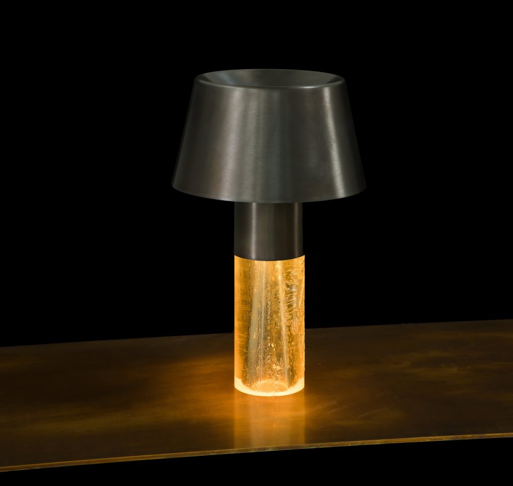 Ghost Lamp Table, central element in resin, light diffuser in steel on a table on a black background.