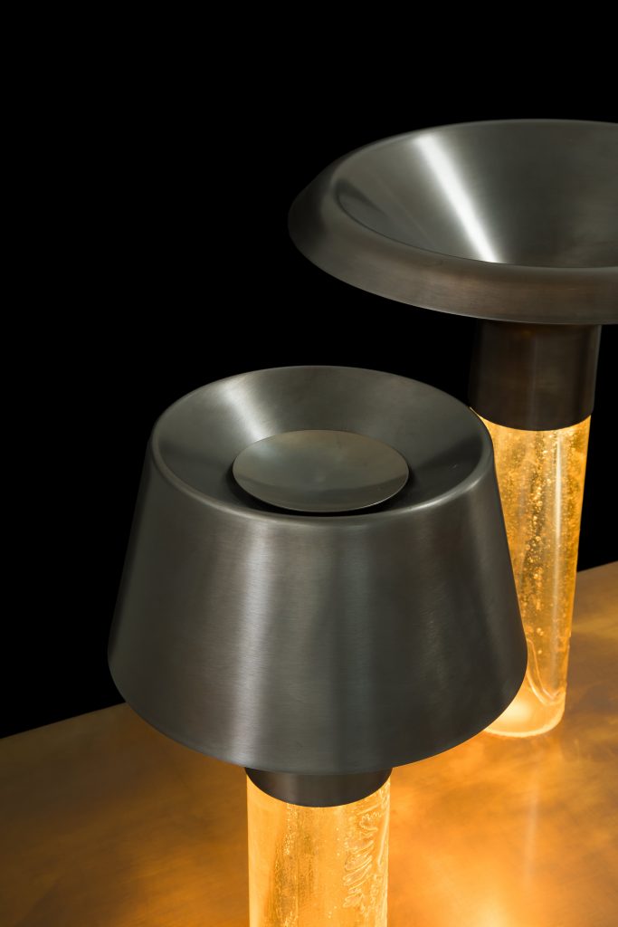 Two Ghost Lamp Tables, resin central element and steel light diffuser on black background.