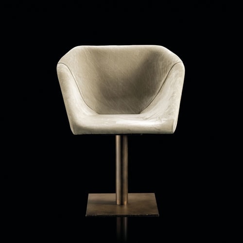 Hexagon chair, upholstered in white leather and central leg finished in brass on a black background.