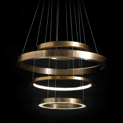 LED Pendant Light Ring made up of four brass rings using suspension wires on a black background.