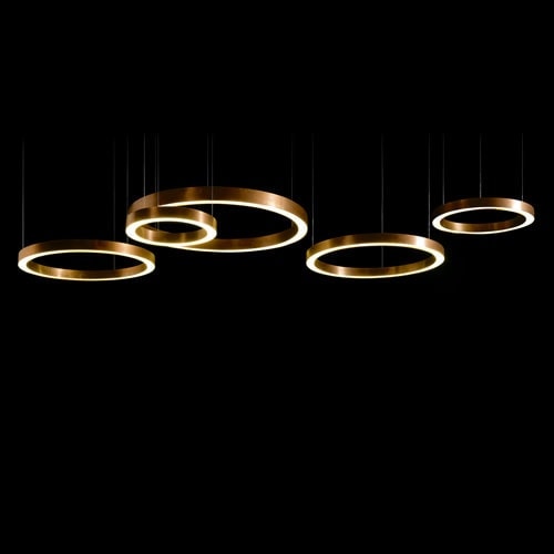 Ring-shaped lamps made of burnished brass in gold tone on a black background.
