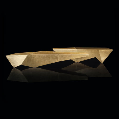 tables made of stone with internal metal structure covered with stone in a golden tone on a black background