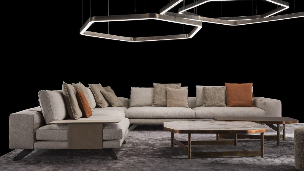 Two Opus Sofas upholstered in gray fabric with four legs in black steel with poufs and a table on a black background.