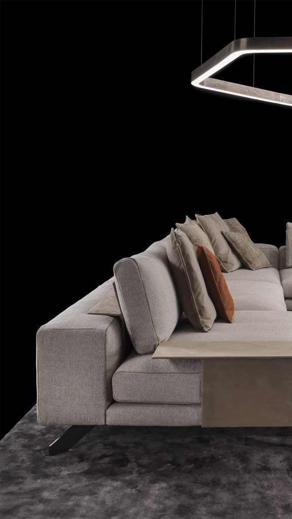 Two Opus Sofas upholstered in gray fabric with four legs in black steel with poufs and a table on a black background.