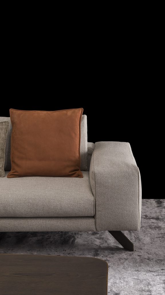 Closeup of Opus Sofa upholstered in gray fabric with four legs in black steel with poufs and a table on a black background.