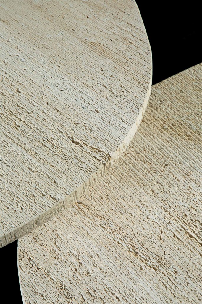 Two round Primitive Tables top in white ostuni stone on a black background.