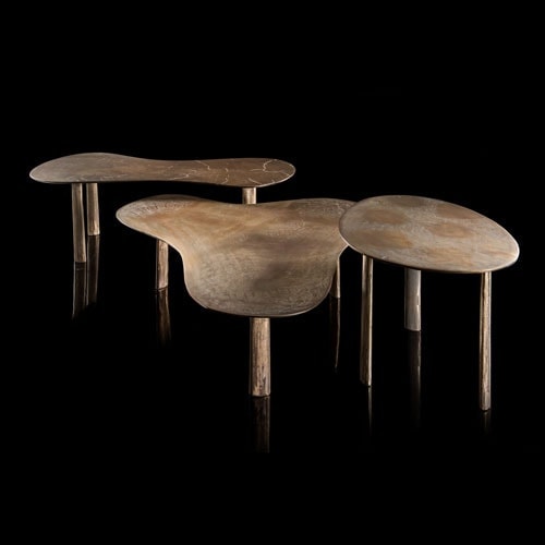 Two Puddle side table made of metal in bronze color creating an irregular shape with one round, one with two and one with three rounded tips on a black background.