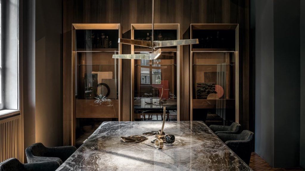 pendant lamp made of cast bronze with a design in geometric lines in a gray tone