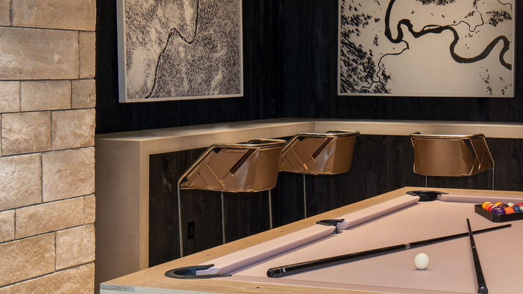 Three Strip Stools. Structure in curved black metal frame, seat covered with brown leather on a study room.