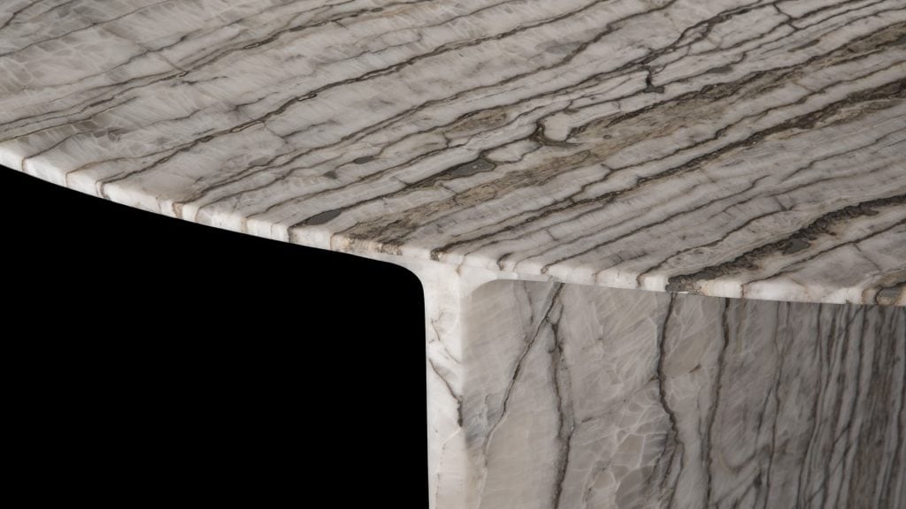 Closeup of round Synapses Table with three legs, white and black marble lines on a black background.