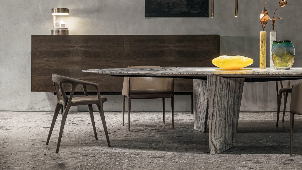Round Synapses Table with three legs, white and black marble lines in a dining room.