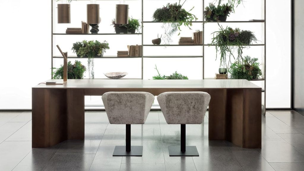 Time Table with two legs, structure in natural wood cover in burnished brass in a dining room.