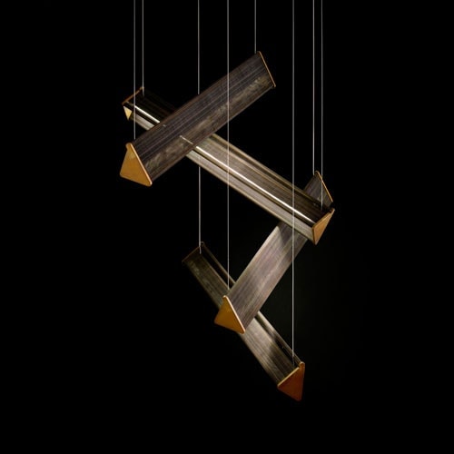 Four Y Lights of y shaped body with steel suspension cables. Finish structure in brass on a black background.