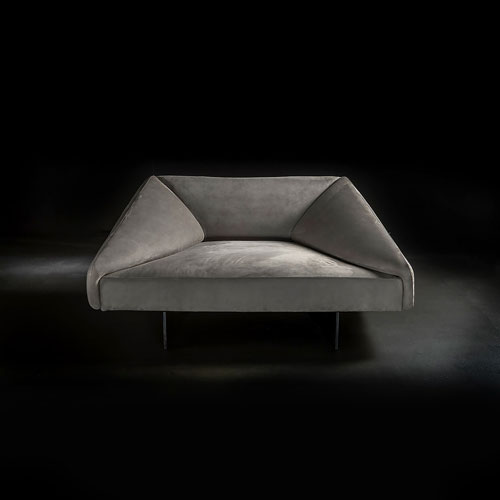 Armchair made of solid wood covered in foam upholstered in gray velvet on a black background