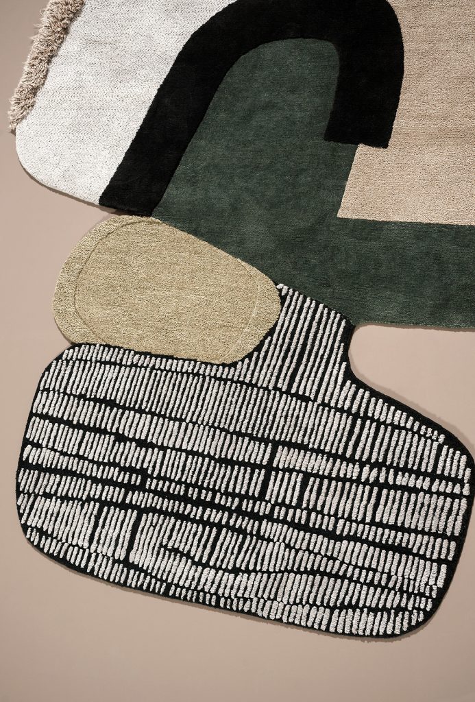 rug that highlights its design and color such as black, green, yellow and white