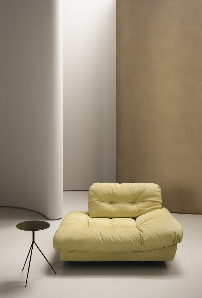 padded armchair made of leather in a yellow tone in a living room
