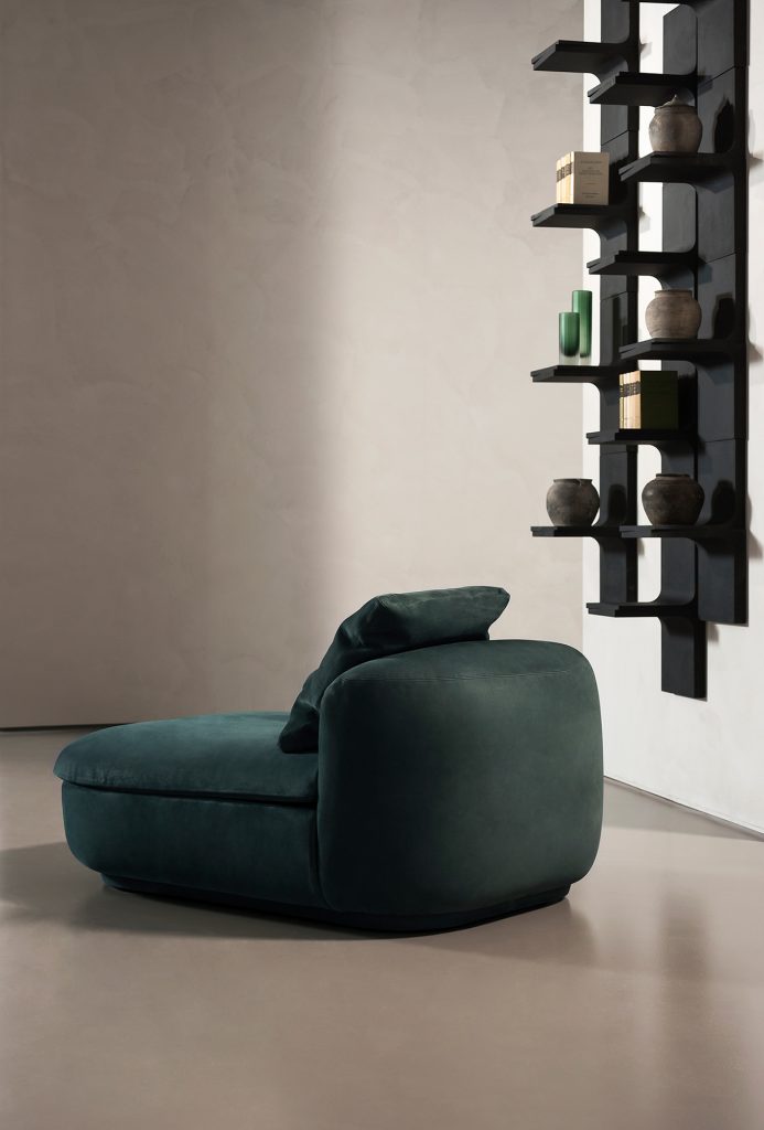 armchair with armrests in a green tone upholstered in suede leather