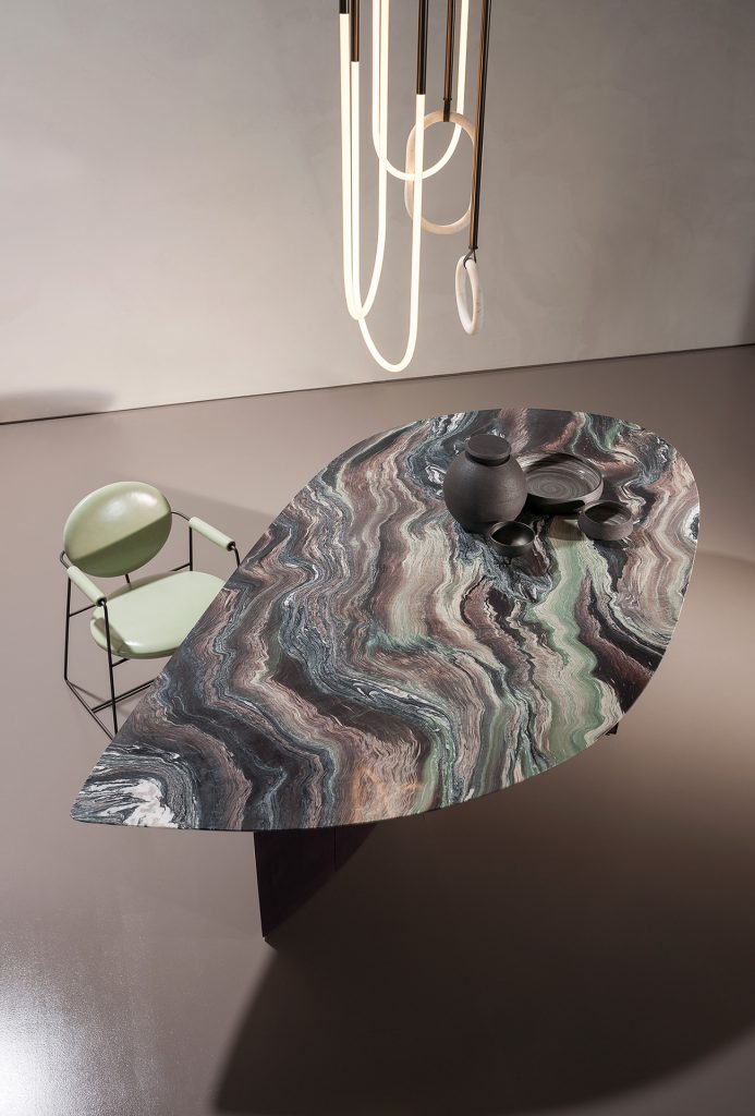 Drop-shaped table made of marble in a varied color tone in an office
