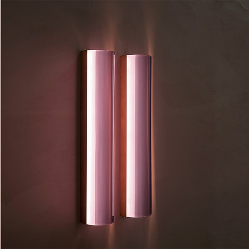 two-panel wall light made of glass and aluminum in a pink tone on a black background