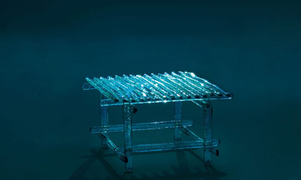 transparent glass table on a bright blue background.