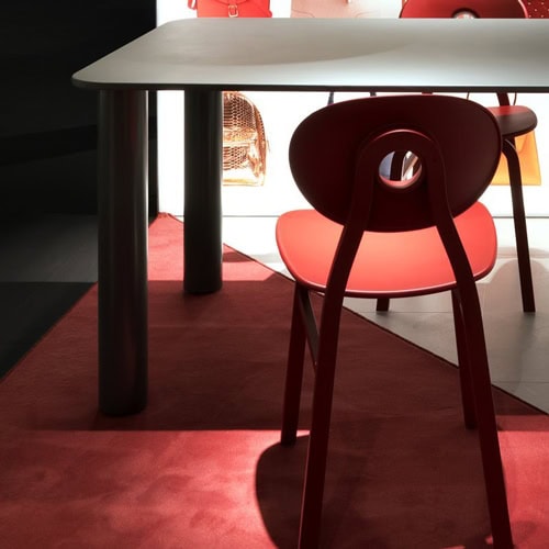 Marcuso table with a gray top and four black sturdy metal legs in a dining room.