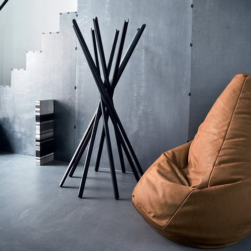 Sciangai coat stand with a distinctive wooden structure that resembles a bundle of sticks in a living room.