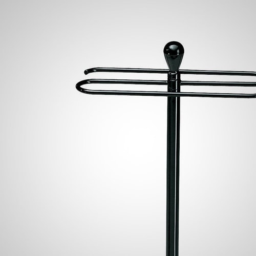 Servietto coat rack with a S form top and a slim black metal base on a white background.