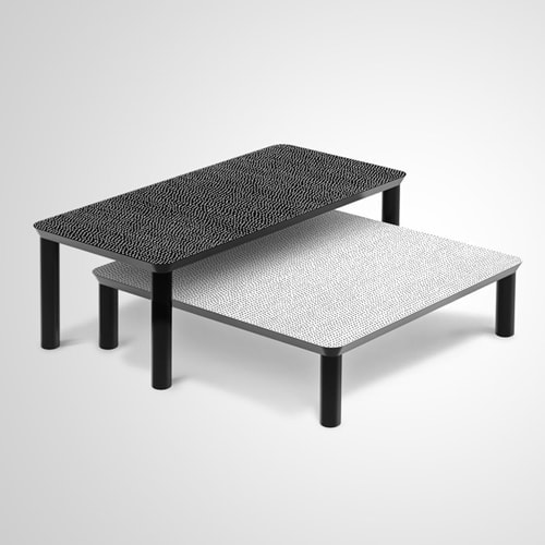 Spotty side table. Legs in black, one with black dots on white top and one with white dots on black top on a white background.