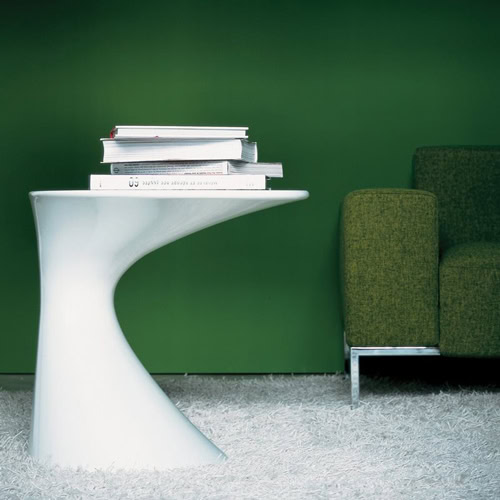 Tod table with, top and base in round shape in white color in a living room.