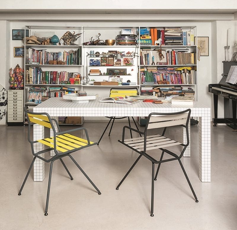 three chairs made from strips in a yellow and white tone with an iron structure in a black tone