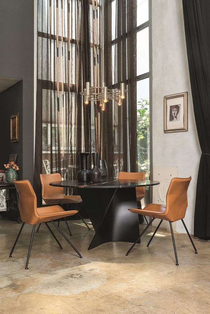 four chairs made on a gray steel base and upholstered in removable polyurethane covers in an orange tone
